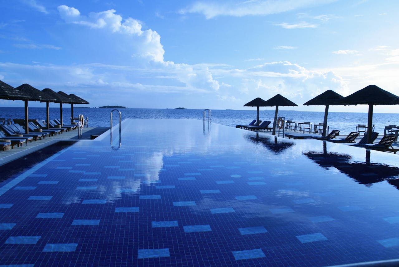 Luxurious infinity pool with ocean view at a tropical resort. Ideal for relaxation.